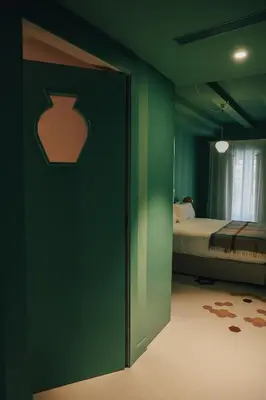 a bedroom with a green wall with a bed in it at Casa Clarita in Valencia