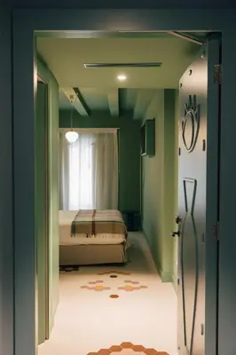 a bedroom with a bed in a room with green walls at Casa Clarita in Valencia