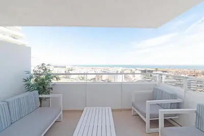 a balcony with benches and a view of the city at Global Vacacional, Moderno apartamento de dos terrazas con vistas al mar y a la montaña in Canet de Berenguer