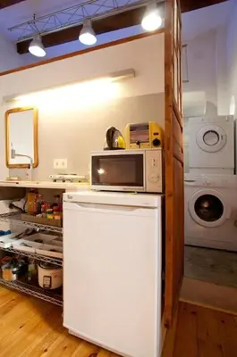 a kitchen with a microwave on top of a refrigerator at TYNE ARTIS HOUSE in Valencia