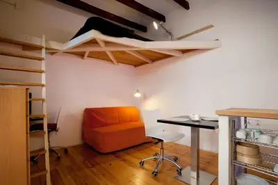 a room with an orange chair and a table in a room at TYNE ARTIS HOUSE in Valencia