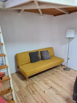 a yellow couch in the middle of a room at TYNE ARTIS HOUSE in Valencia