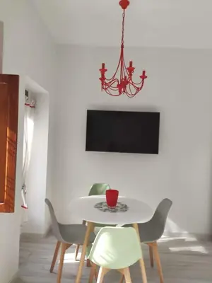 a dining room with a table with chairs and a chandelier at Barcabanyal in Valencia