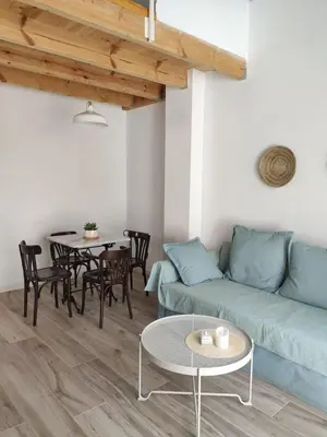a living room with a couch and a table at Barcabanyal in Valencia