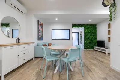 a living room with a couch and a tv at ApartUP Ruzafa Vertical in Valencia