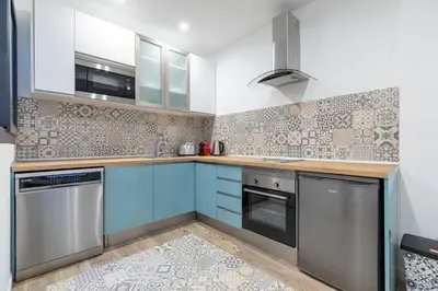 a kitchen and living room with a table and chairs at ApartUP Ruzafa Vertical in Valencia