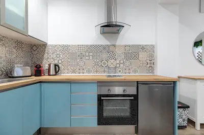 a kitchen and living room with a table and chairs at ApartUP Ruzafa Vertical in Valencia