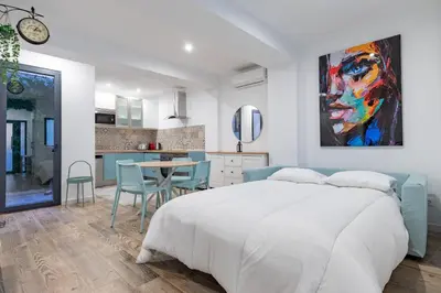 a living room with a blue couch and a table at ApartUP Ruzafa Vertical in Valencia