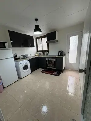 a kitchen with a white refrigerator and a washing machine at Appartement Célia in Algemesí