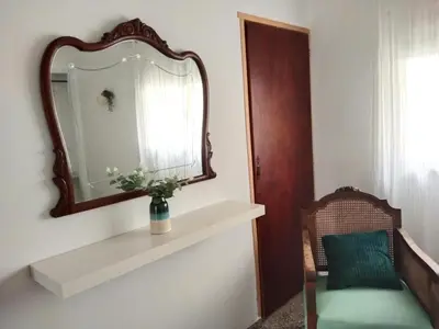 a mirror and a vase on a shelf in a room at La Casica in Chulilla