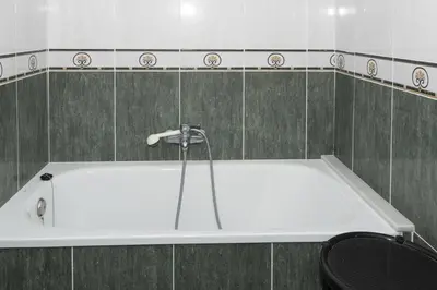 a white bath tub in a tiled bathroom at Levante, 6-J in Cullera