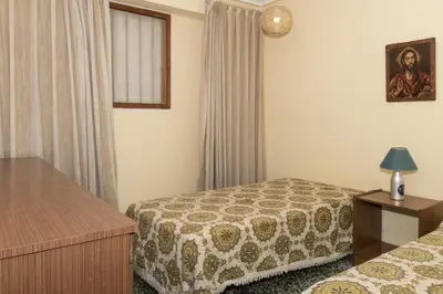 a hotel room with two beds and a window at Levante, 6-J in Cullera