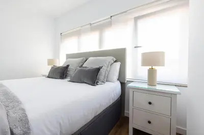 a bedroom with a white bed and a window at FLORIT FLATS - The Apolo Studio in Valencia