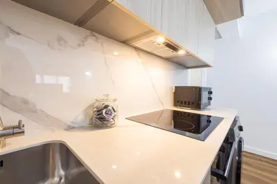 a kitchen with a white counter top and a microwave at FLORIT FLATS - The Apolo Studio in Valencia