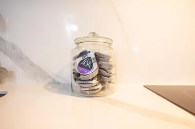 a glass jar filled with money sitting on a counter at FLORIT FLATS - The Apolo Studio in Valencia