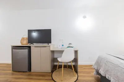 a bedroom with a desk with a computer and a white chair at FLORIT FLATS - The Apolo Studio in Valencia