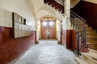 an empty hallway with a wooden door and stairs at cozy loft patio+pool +wifi in Valencia