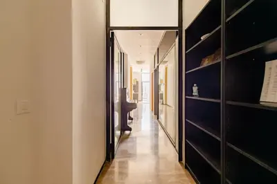 a hallway with black shelves and a long hallway at cozy loft patio+pool +wifi in Valencia