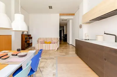 a kitchen and living room with a table and chairs at cozy loft patio+pool +wifi in Valencia