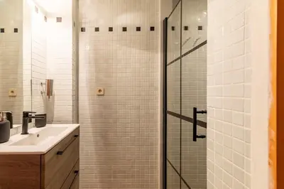 a bathroom with a shower with a sink and a toilet at cozy loft patio+pool +wifi in Valencia