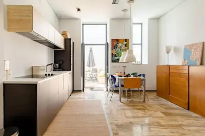 a kitchen with white cabinets and a table in it at cozy loft patio+pool +wifi in Valencia