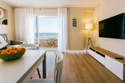 a living room with a table with a bowl of fruit at A Casa Martinez Playa Sin Ascensor in Mareny Barraquetas