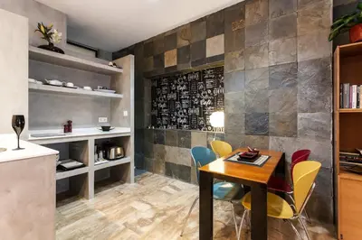 a dining room with a table and chairs at Pequeño Loft en Ruzafa wifi in Valencia
