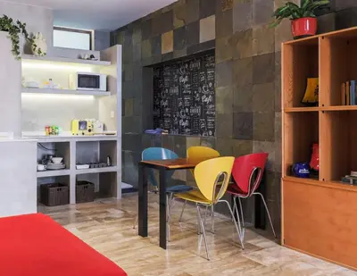 a dining room with a table and chairs at Pequeño Loft en Ruzafa wifi in Valencia