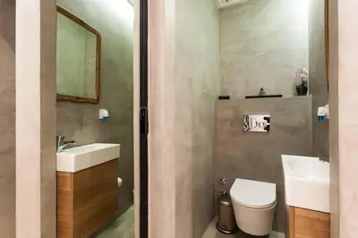 a bathroom with a sink and a toilet and a mirror at Pequeño Loft en Ruzafa wifi in Valencia