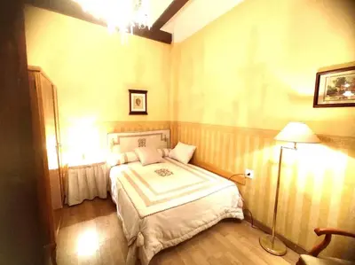 a bedroom with a bed and a lamp in it at Encantadora casa de pueblo in Sagunto