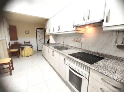 a kitchen with a sink and a stove top oven at Encantadora casa de pueblo in Sagunto