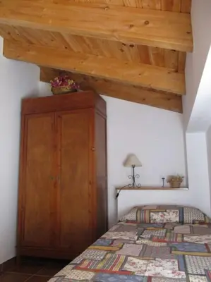 a bedroom with a bed and a wooden ceiling at Casa La Higuera in Chulilla