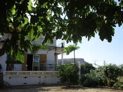 a white house with a balcony on top of it at Casa La Higuera in Chulilla