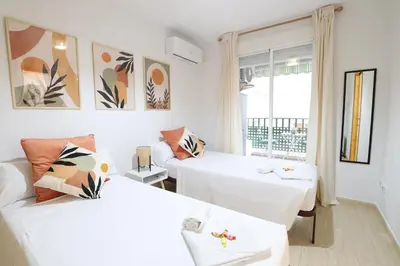 a living room with two beds and a couch at Adorable apartment 60m from the beach by Hometels in Puerto de Sagunto