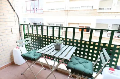 a table and two chairs on a balcony at Adorable apartment 60m from the beach by Hometels in Puerto de Sagunto