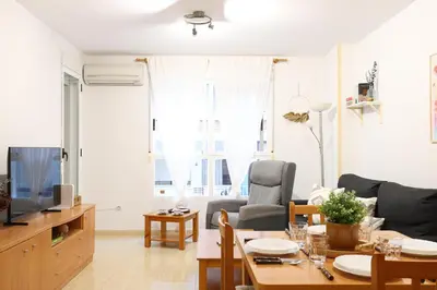 a living room with a couch and a table and a tv at Adorable apartment 60m from the beach by Hometels in Puerto de Sagunto