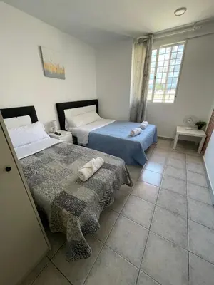 a bedroom with two beds and a window at MHrosa in Valencia