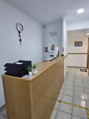 an office with a reception desk with a clock on the wall at MHrosa in Valencia