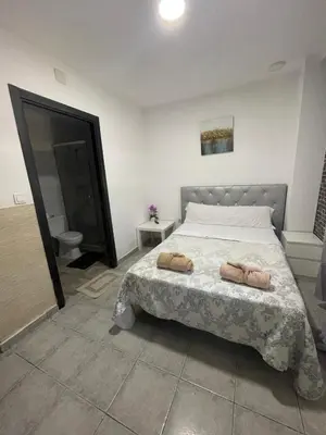 a bedroom with a bed with two towels on it at MHrosa in Valencia