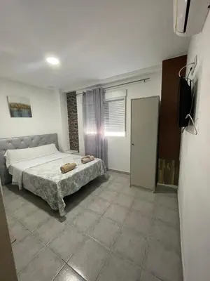 a bedroom with a bed and a television in it at MHrosa in Valencia