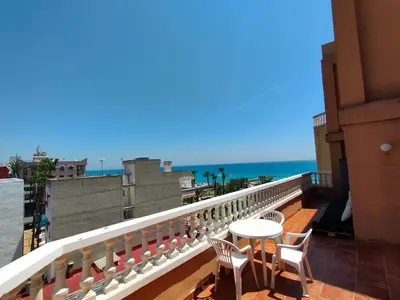 a balcony with a table and chairs and the ocean at Playa Paradís - Primera linea de playa - AP-7 3min - Self check-in 24h in Moncófar