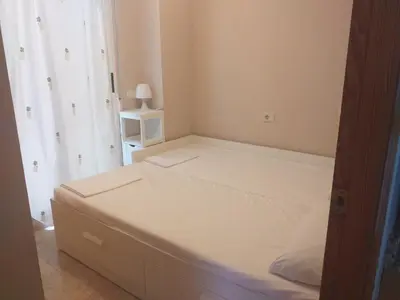 a small bedroom with a white bed in a room at Playa Paradís - Primera linea de playa - AP-7 3min - Self check-in 24h in Moncófar