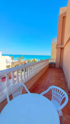 a balcony with two white chairs and the ocean at Playa Paradís - Primera linea de playa - AP-7 3min - Self check-in 24h in Moncófar