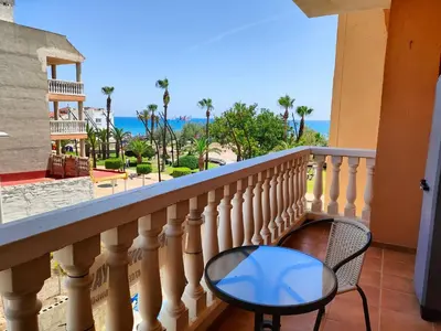 a balcony with a chair and a view of the ocean at Playa Paradís - Primera linea de playa - AP-7 3min - Self check-in 24h in Moncófar