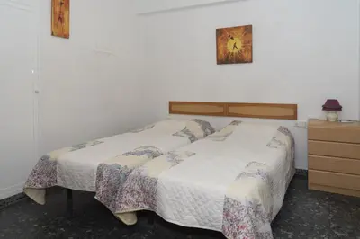 a bedroom with a bed and a dresser and a bed sidx sidx sidx sidx at Prado, A-5-52 PK INT 85 in Cullera