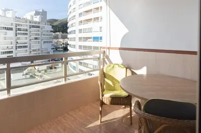 a table and chairs on a balcony with a view at Prado, A-5-52 PK INT 85 in Cullera