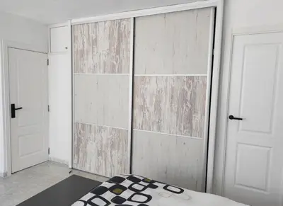 a room with two doors and a bed in it at Terrace & Sea Views in Cullera in Faro de Cullera