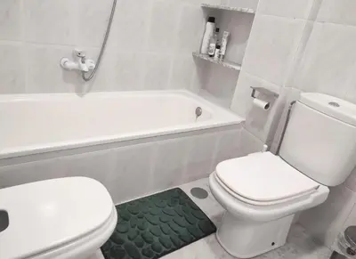a white bathroom with a toilet and a bath tub at Terrace & Sea Views in Cullera in Faro de Cullera