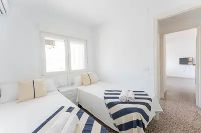 a white room with two beds and a couch at Precioso apartamento en altura in Altura