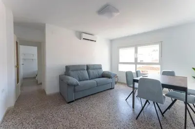 a living room with a couch and a table and chairs at Precioso apartamento en altura in Altura